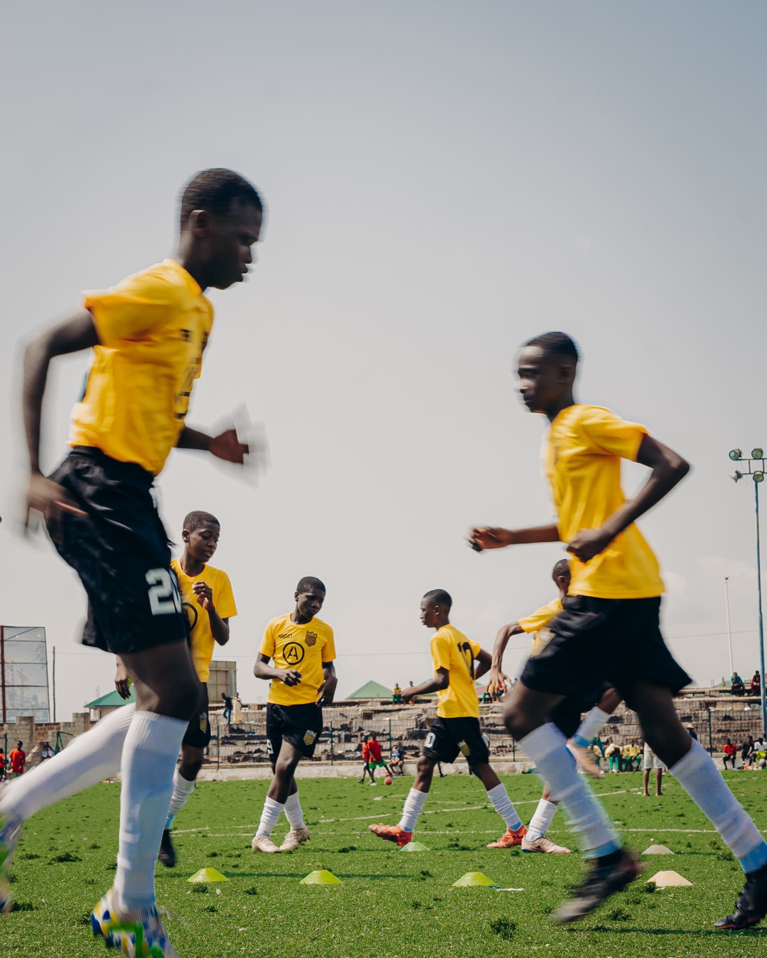 Players running through a cone warm-up drill
