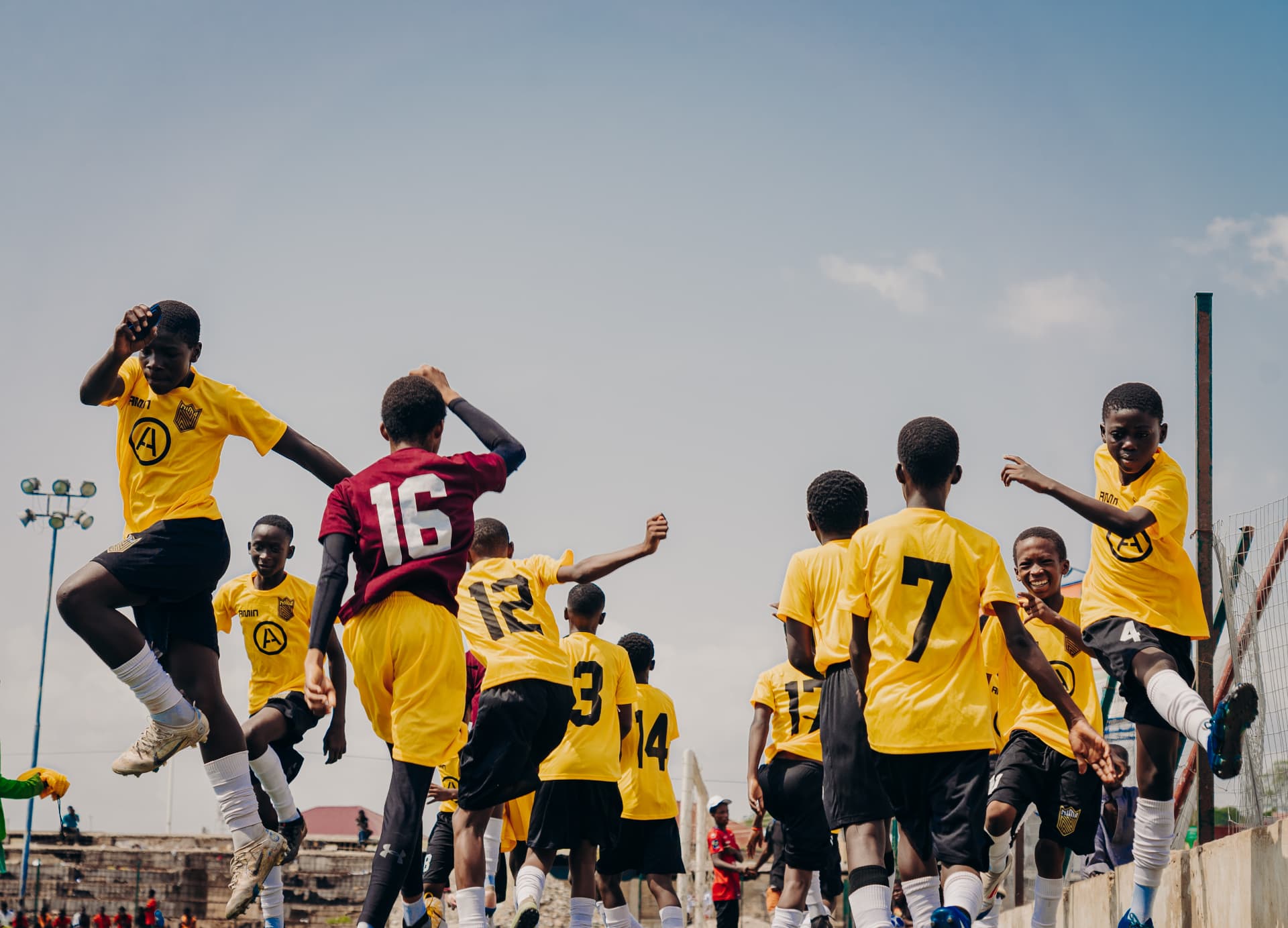 Grassroots squad jumping and celebrating together
